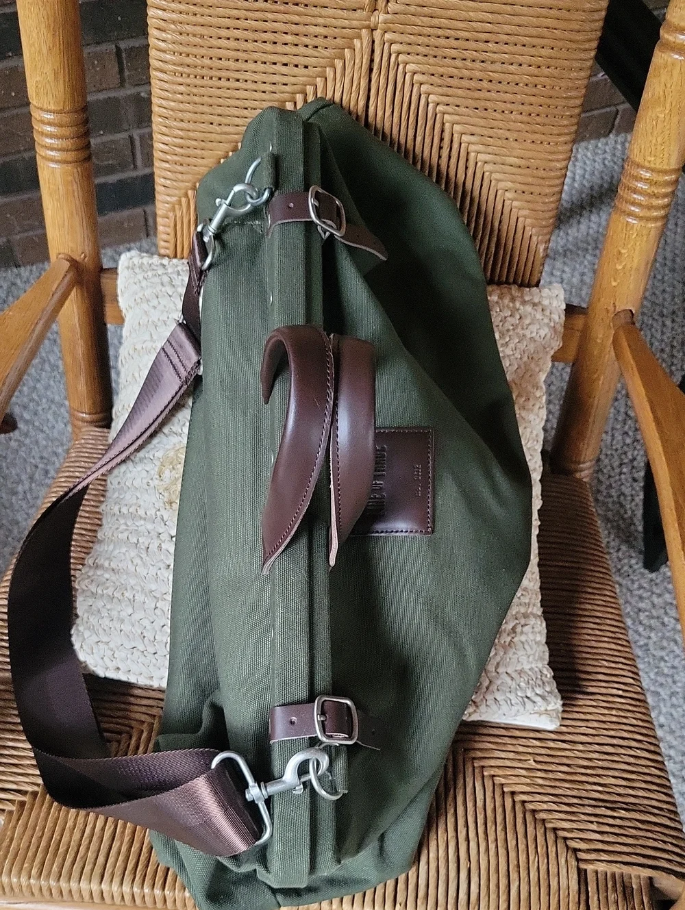 Line of Trade green military duffle sack with brown canvas strap